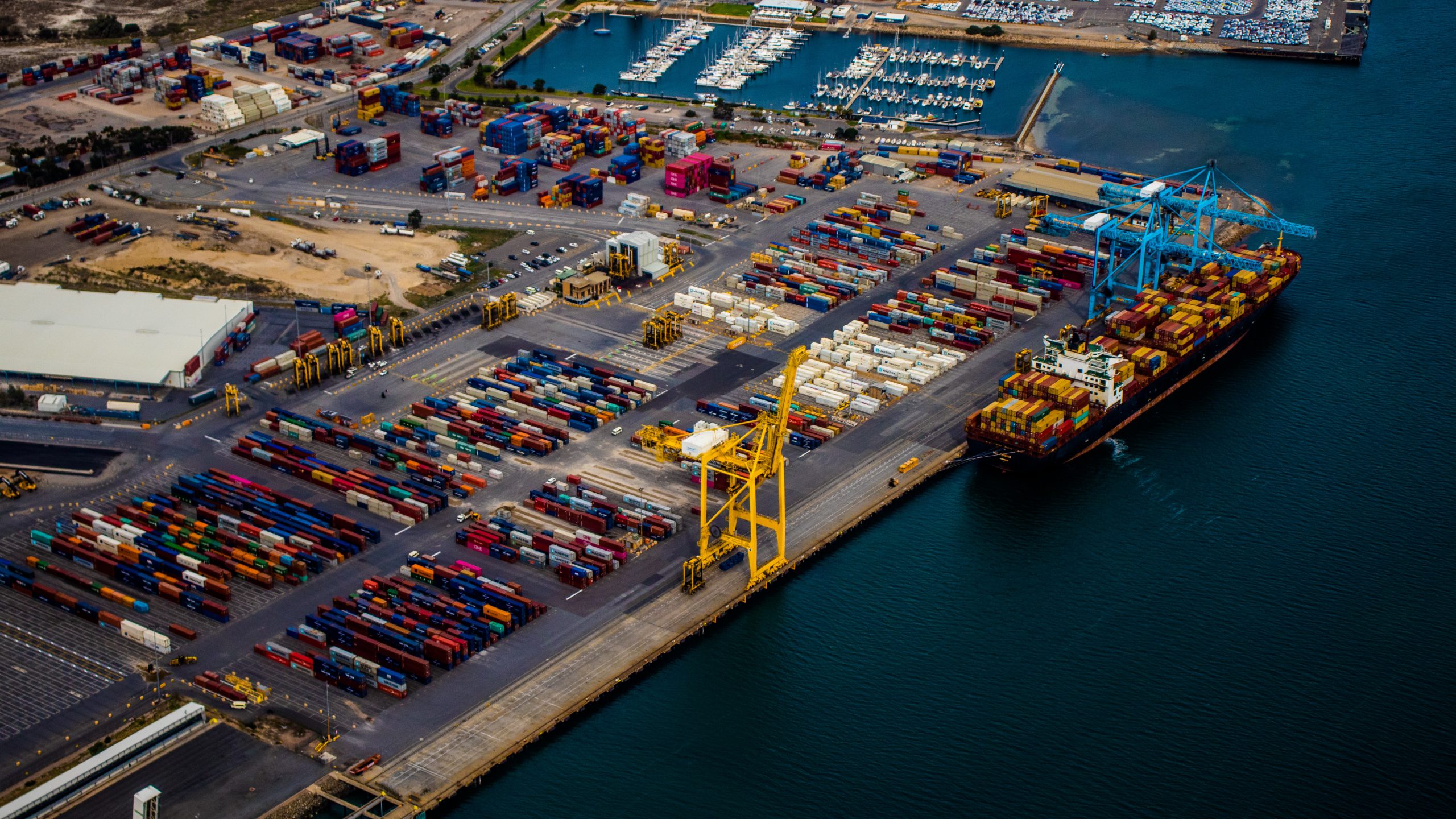 freight containers and ship sitting at port